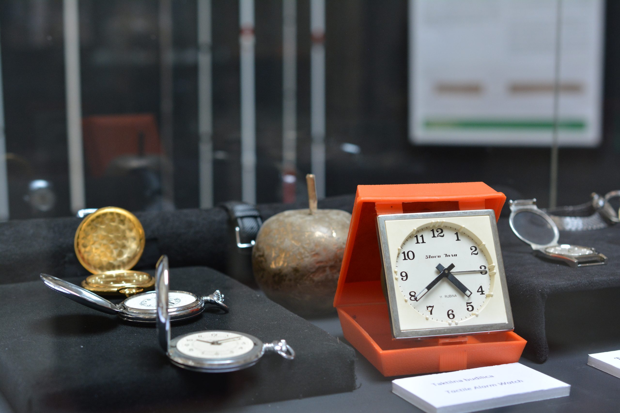 v vitrini razstavljeni pripomočki za slepe in slabovidne